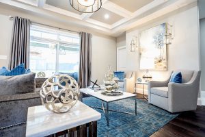 Modern living room with silver and blue tones.